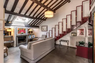 a living room with a staircase and a couch at Domus in Via Del Corso in Rome
