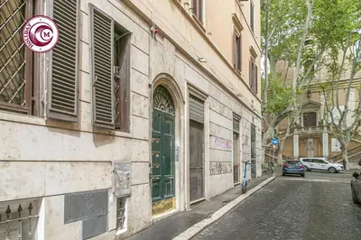 a building with a green door on the side of a street at C M Via Veneto Sweet Apartment in Rome