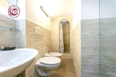 a bathroom with a toilet and a sink at C M Via Veneto Sweet Apartment in Rome