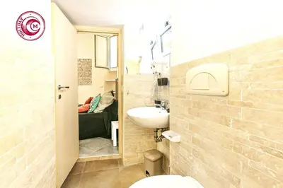a small bathroom with a sink and a toilet at C M Via Veneto Sweet Apartment in Rome