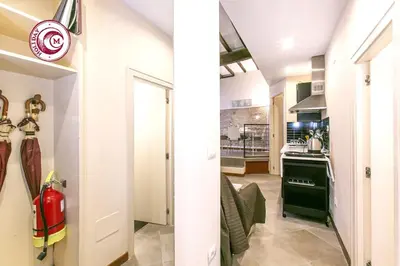 a kitchen and a living room with a fire hydrant at C M Via Veneto Sweet Apartment in Rome