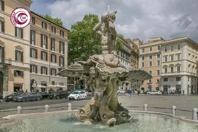 a statue in the middle of a city street at C M Via Veneto Sweet Apartment in Rome