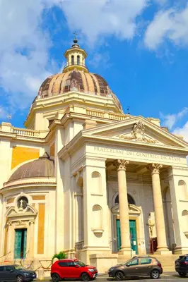 a building with cars parked in front of it at Roma Tourist House in Rome