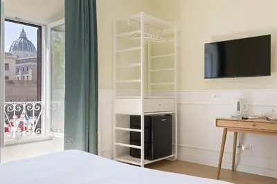 a bedroom with a bed and a tv and a window at Risorgimento 9 - Guest House in Rome