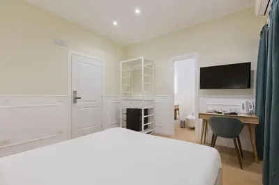 a bedroom with a bed and a desk and a tv at Risorgimento 9 - Guest House in Rome
