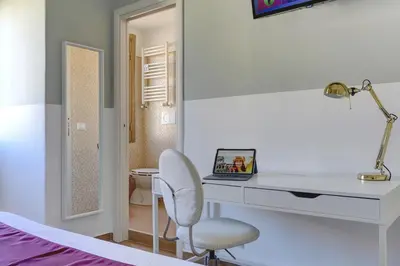 a bedroom with a desk and a chair and a bed at Furio Camillo Studio - Metro A - Netflix in Rome