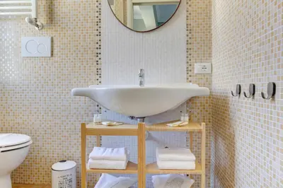 a bathroom with a sink and a toilet at Furio Camillo Studio - Metro A - Netflix in Rome