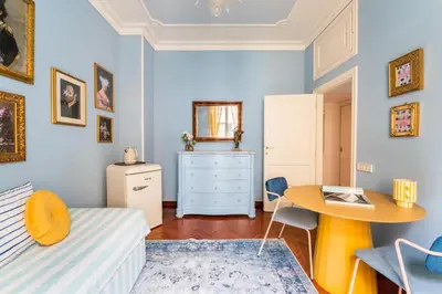 a bedroom with a bed and a desk and a table at Casa Tudor, Charmy Eccentric Flat in Piccola Londra 10 Min from City Center in Rome