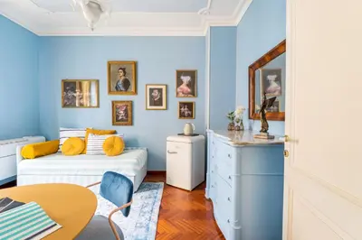 a blue bedroom with a bed and a table at Casa Tudor, Charmy Eccentric Flat in Piccola Londra 10 Min from City Center in Rome