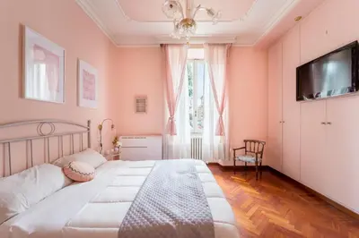 a bedroom with pink walls and a large bed at Casa Tudor, Charmy Eccentric Flat in Piccola Londra 10 Min from City Center in Rome