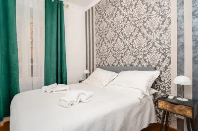 a bedroom with a white bed with towels on it at OLEUM Roma Veneto in Rome