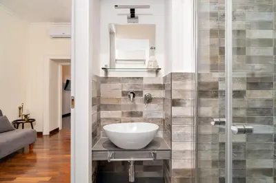 a bathroom with a sink and a mirror at OLEUM Roma Veneto in Rome