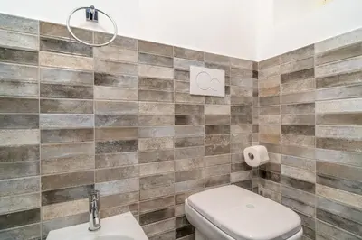 a bathroom with a toilet and a sink at OLEUM Roma Veneto in Rome