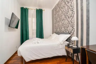a small bedroom with a bed and a window at OLEUM Roma Veneto in Rome