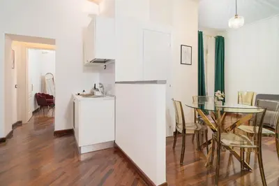 a kitchen and dining room with a glass table at OLEUM Roma Veneto in Rome