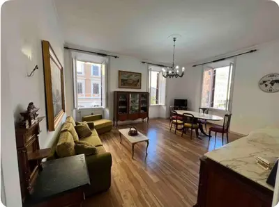 a living room with a couch and a table at Maison Leone IV 22 in Rome