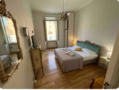 a bedroom with a bed and a mirror in a room at Maison Leone IV 22 in Rome