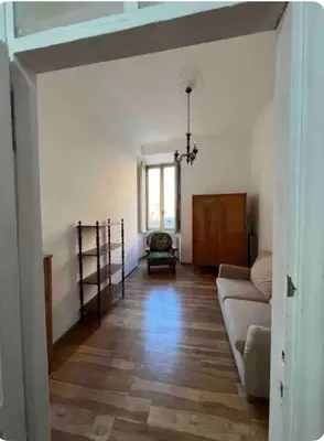 a living room with a couch and a window at Maison Leone IV 22 in Rome