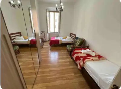 a room with two beds and a mirror at Maison Leone IV 22 in Rome