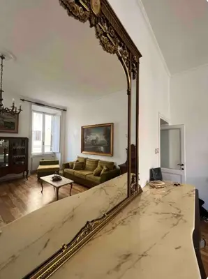 a large mirror in a living room with a couch at Maison Leone IV 22 in Rome