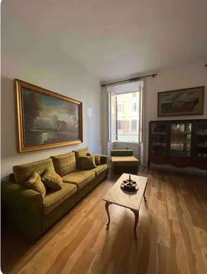 a living room with a couch and a coffee table at Maison Leone IV 22 in Rome