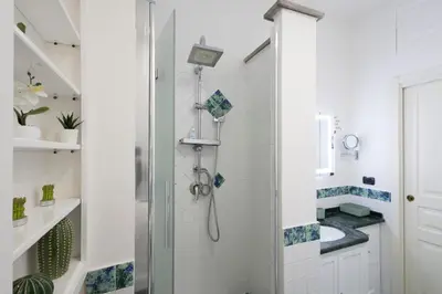 a bathroom with a shower with a glass door at La Casa Di Alice in Rome