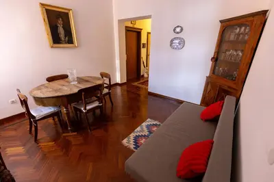 a living room with a table and a dining room at Rome Historic Center Stylehouse in Rome