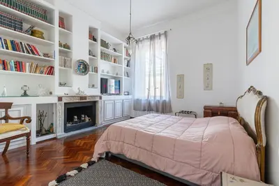 a bedroom with a bed and a fireplace at Rome Historic Center Stylehouse in Rome