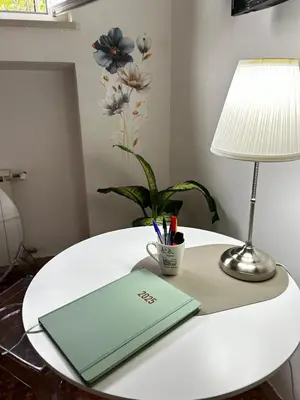 a table with a laptop and a lamp on it at BAM BAM TIBURTINA Guesthouse in Rome