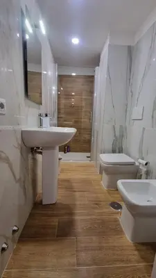 a bathroom with two sinks and a toilet and a tub at BAM BAM TIBURTINA Guesthouse in Rome