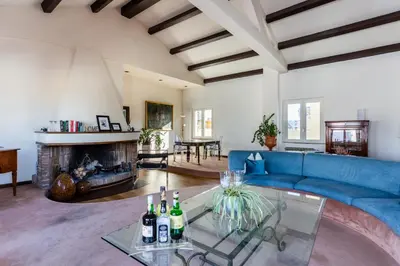 a living room with a blue couch and a fireplace at Saint Peter's Luxury Terrace Suites in Rome