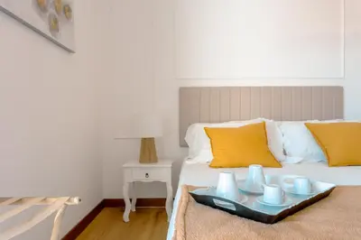 a bedroom with a bed with a tray with mugs on it at Saint Peter's Luxury Terrace Suites in Rome