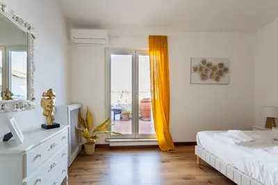 a bedroom with a bed and a window with a view at Saint Peter's Luxury Terrace Suites in Rome