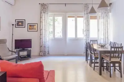 a living room with a table and chairs and a couch at La Casa Di Mamma in Rome