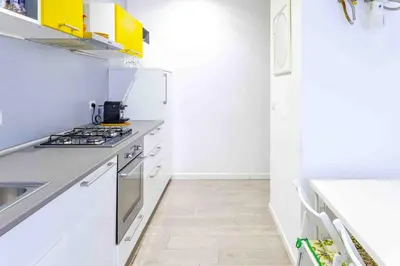 a kitchen with white counters and a stove top oven at La Casa Di Mamma in Rome