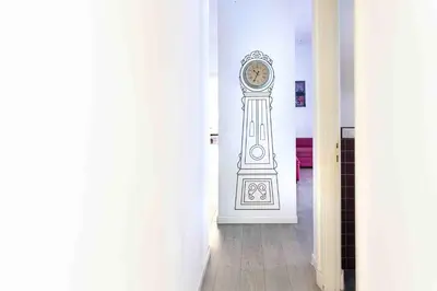 a clock on the wall in a hallway at La Casa Di Mamma in Rome