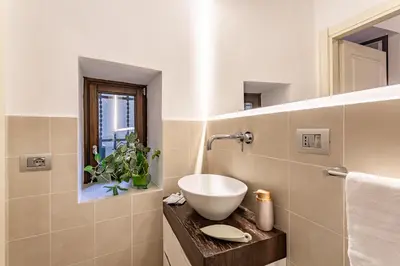a bathroom with a bowl sink on a counter at iFlat Modern & Comfortable apt in Trastevere in Rome