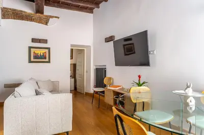a living room with a white couch and a table at iFlat Modern & Comfortable apt in Trastevere in Rome