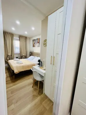 a bedroom with a bed and a desk and a table at Segesta Rooms in Rome