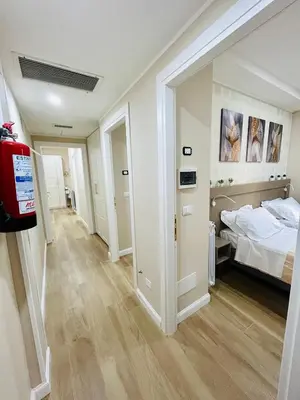 a large bedroom with a bed and a hallway at Segesta Rooms in Rome