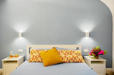 a bedroom with a bed with two night stands at HC - Chez Le Roi Luxury Apartment in Rome
