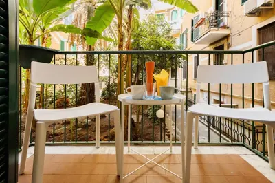 two chairs and a table on a balcony at HC - Chez Le Roi Luxury Apartment in Rome