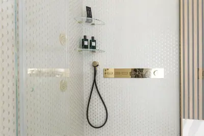 a bathroom with a shower with a shower head at Tritone Luxury Suites Piazza del Popolo in Rome