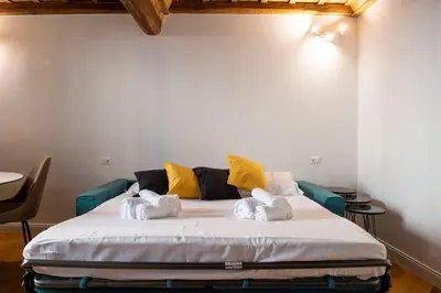 a bedroom with a bed with towels on it at Costaguti Holiday Apartment in Rome