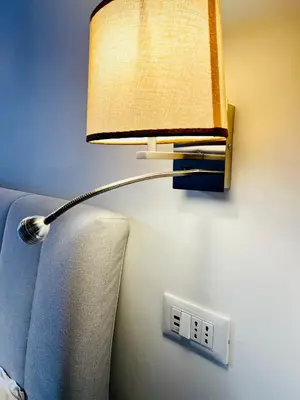 a lamp with a lightswitch and a clock on a wall at Costaguti Holiday Apartment in Rome
