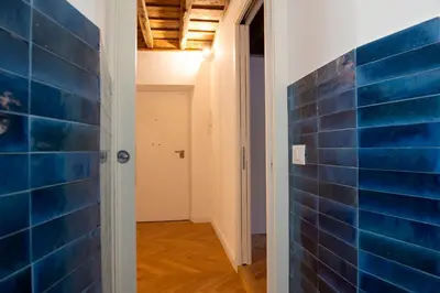 a hallway with blue tile on the wall at Costaguti Holiday Apartment in Rome