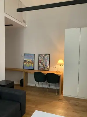 a living room with a table and two chairs at Nizza 33 in Rome