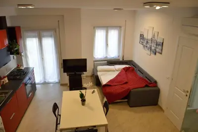 a small living room with a bed and a table at Apartment Veio in Rome