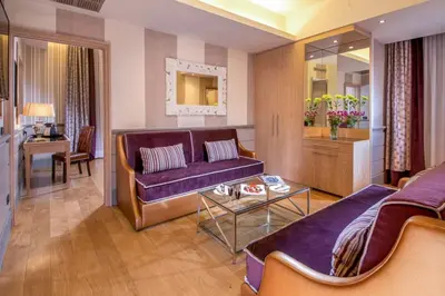 a living room with a purple couch and a table at The Inn at the Spanish Steps Luxury Collection - Spanish Step Suites in Rome