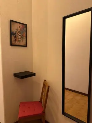 a mirror and a chair in a room at ROMA Appia in Rome